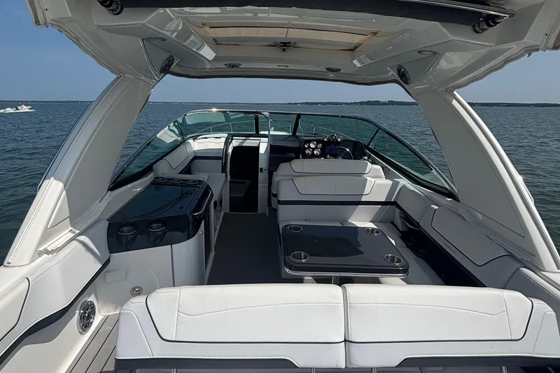 Slide: The Image of 2021 Formula 350ss luxury boat interior with seating and table on open water. - 14