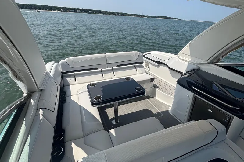 Slide: The Image of 2021 Formula 350ss boat interior with luxurious seating and table on open water. - 19