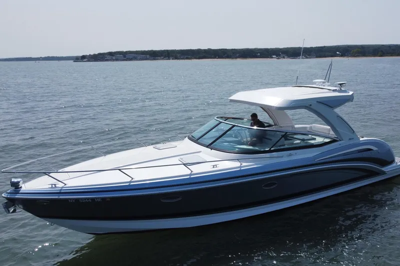 Slide: The Image of 2021 Formula 350ss boat cruising on calm waters under a clear sky. - 2