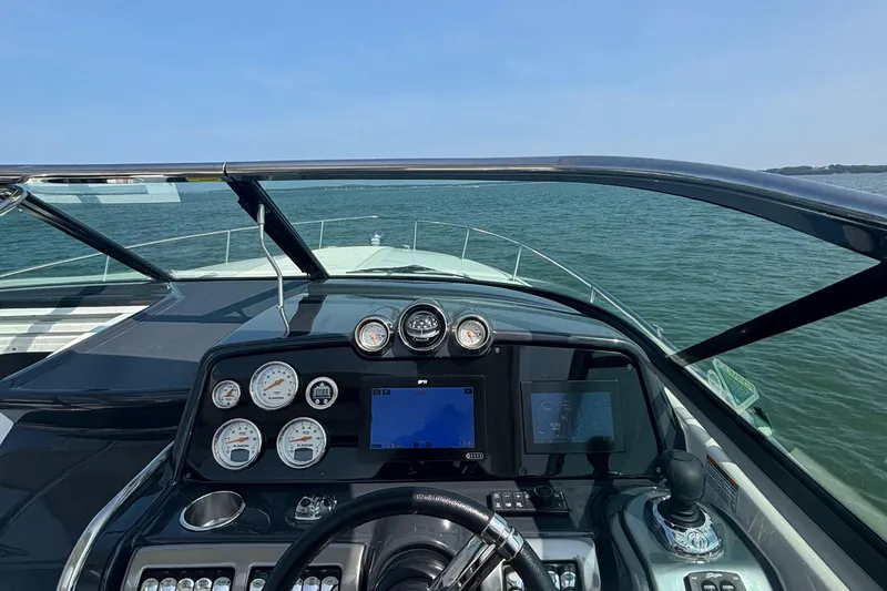 Slide: The Image of Cockpit view of 2021 Formula 350ss boat on open water, showcasing dashboard and controls. - 22