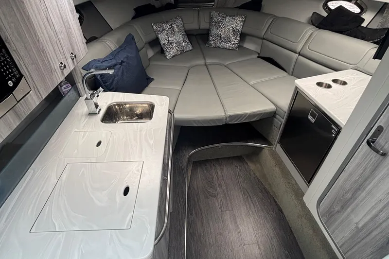 Slide: The Image of 2021 Formula 350ss boat interior with modern kitchenette and cozy seating area. - 29