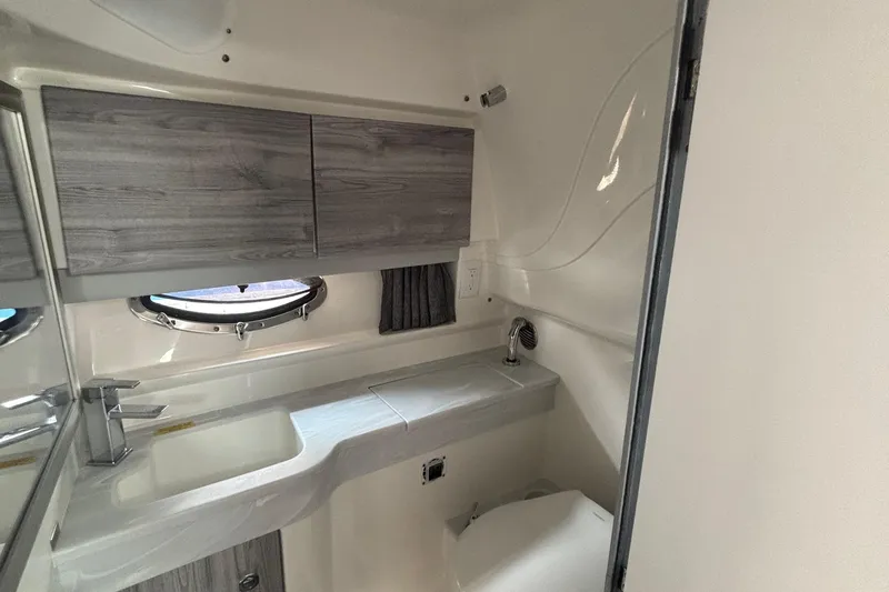 Slide: The Image of Modern bathroom interior in 2021 Formula 350ss boat, featuring sleek cabinetry and porthole window. - 31