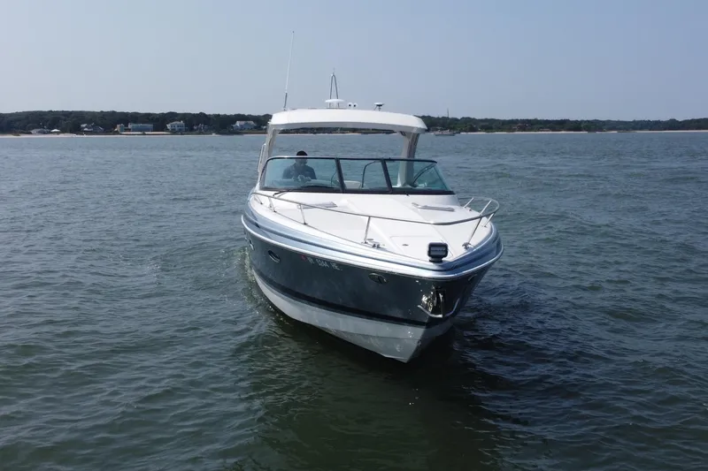 Slide: The Image of 2021 Formula 350ss boat cruising on open water near shoreline. - 49