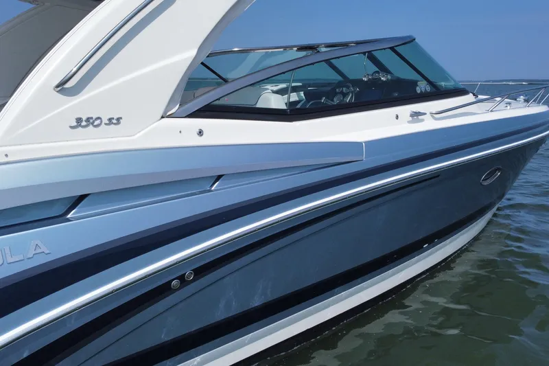 Slide: The Image of 2021 Formula 350ss boat on water, sleek design, blue and white exterior. - 9