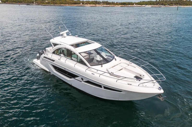 The Image of 2019 Cruisers Yachts Cantius speeding on open ocean, creating dynamic water spray. - 0