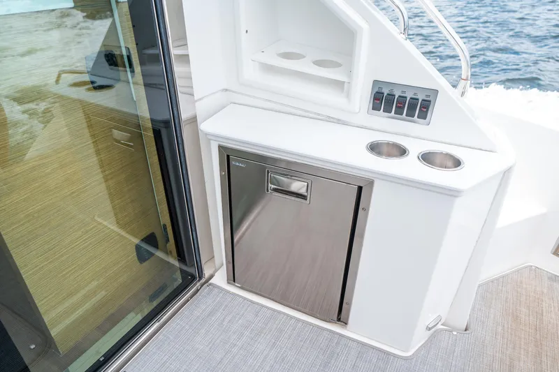 Slide: The Image of 2019 Cruisers Yachts Cantius interior with stainless steel fridge and control panel. - 12