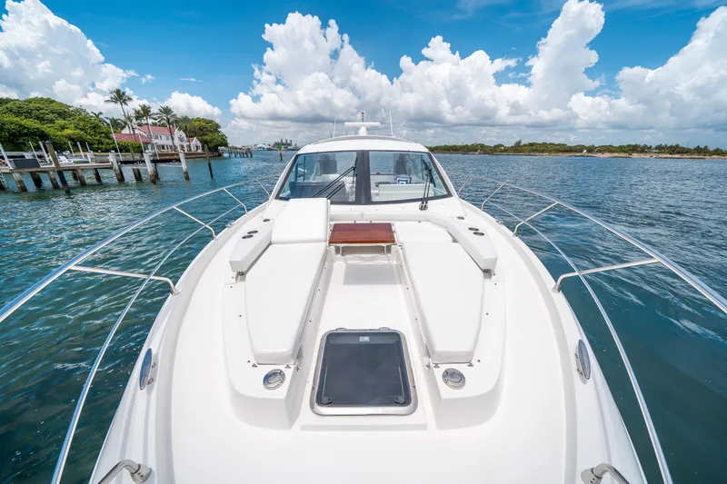 Slide: The Image of 2019 Cruisers Yachts Cantius on serene water, showcasing sleek design and luxury features. - 15