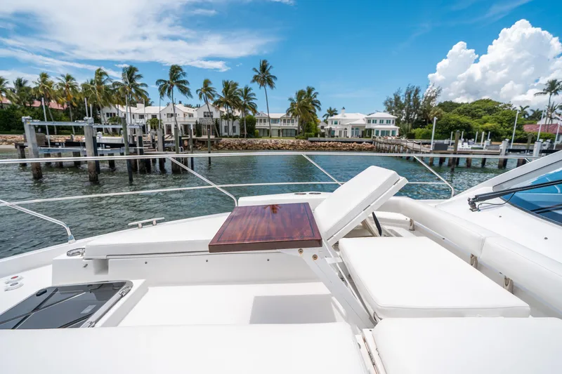 Slide: The Image of Luxurious 2019 Cruisers Yachts Cantius with sun deck, docked near waterfront homes and palm trees. - 17