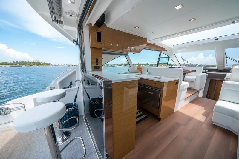 Slide: The Image of Luxurious 2019 Cruisers Yachts Cantius interior with modern kitchen and scenic ocean view. - 19
