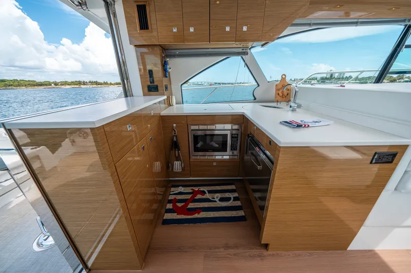 Slide: The Image of Luxurious 2019 Cruisers Yachts Cantius kitchen with modern appliances and scenic ocean view. - 20