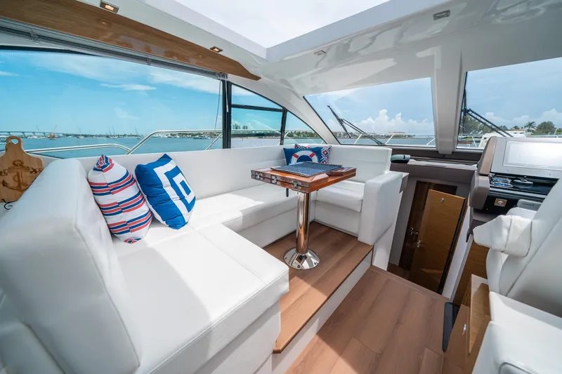 Slide: The Image of Luxurious 2019 Cruisers Yachts Cantius interior with plush seating and nautical-themed decor. - 25