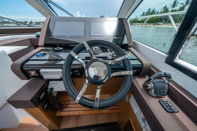 Slide: The Image of 2019 Cruisers Yachts Cantius helm with modern controls and dual displays. - 3