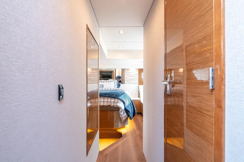 Slide: The Image of Luxurious 2019 Cruisers Yachts Cantius interior hallway leading to a cozy bedroom. - 36