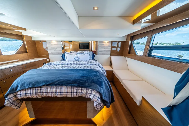 Slide: The Image of Luxurious 2019 Cruisers Yachts Cantius bedroom with elegant wood finish and scenic windows. - 37