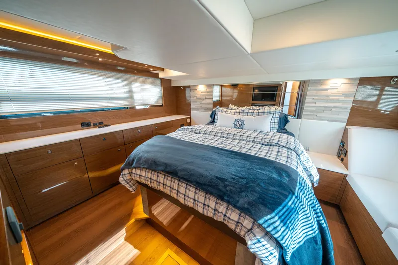 Slide: The Image of Luxurious 2019 Cruisers Yachts Cantius bedroom with modern wood cabinetry and cozy bedding. - 38