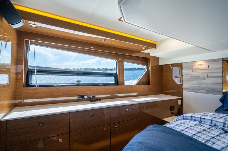 Slide: The Image of Luxurious 2019 Cruisers Yachts Cantius cabin interior with large window and modern wood finish. - 39