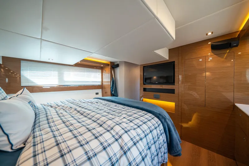 Slide: The Image of Luxurious 2019 Cruisers Yachts Cantius bedroom with plaid bedding and modern wood paneling. - 42