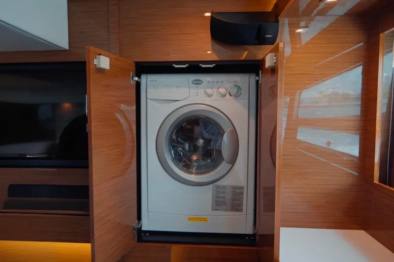 Slide: The Image of Washing machine inside 2019 Cruisers Yachts 50 Cantius, wooden cabinetry, modern interior design. - 44