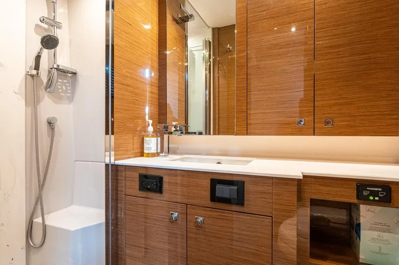 Slide: The Image of Luxurious bathroom in 2019 Cruisers Yachts Cantius, featuring sleek wood cabinetry and modern fixtures. - 46