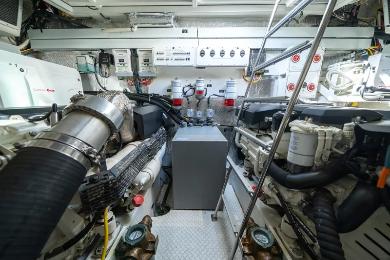 Slide: The Image of Engine room of 2019 Cruisers Yachts Cantius, featuring Cummins Onan generator and advanced machinery. - 48