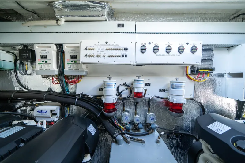 Slide: The Image of Engine room of 2019 Cruisers Yachts Cantius, showcasing electrical panels and equipment. - 53
