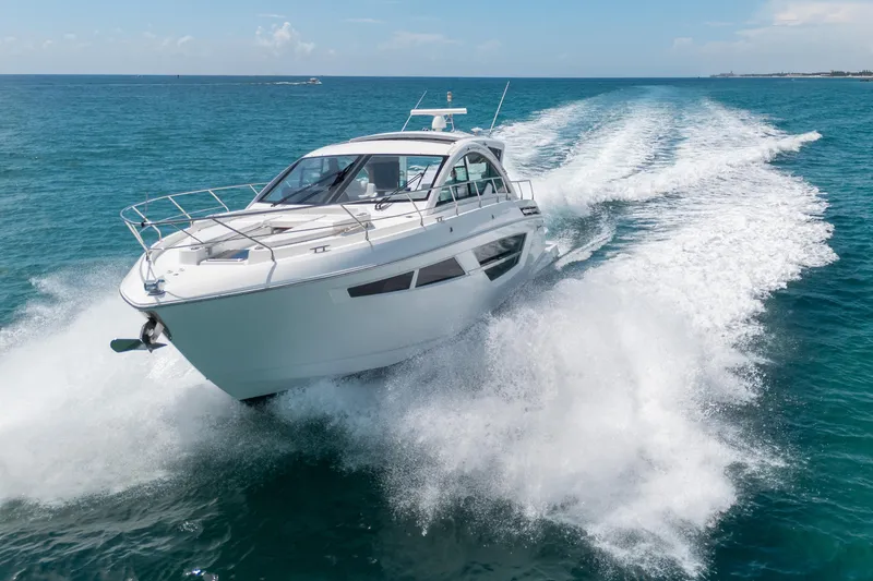 Slide: The Image of 2019 Cruisers Yachts Cantius on open water, showcasing sleek design and luxury features. - 55