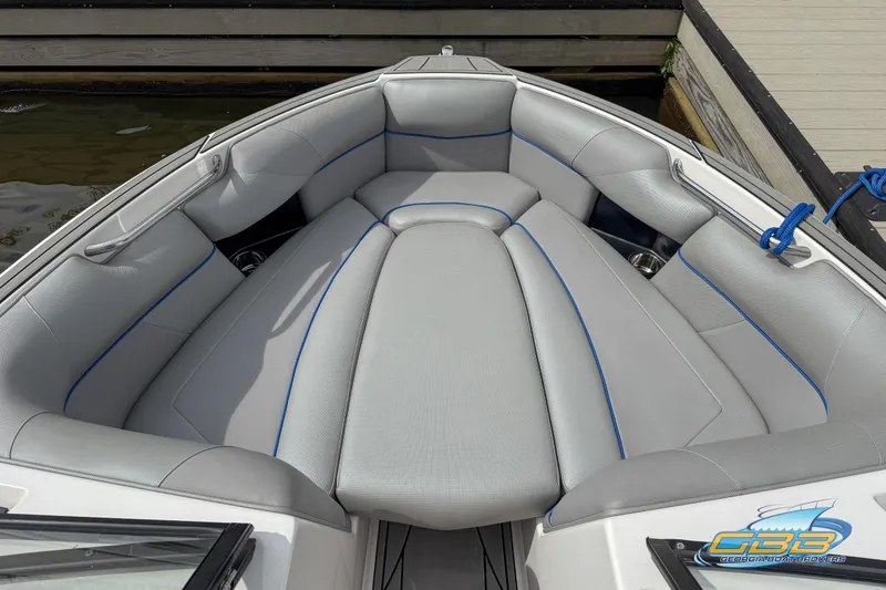 Slide: The Image of 2021 Moomba Craz boat interior with gray seating and blue accents. - 12