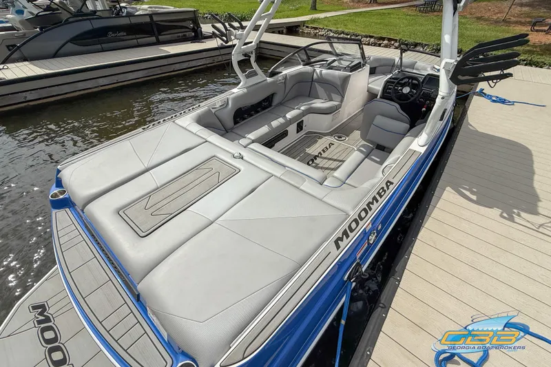 Slide: The Image of 2021 Moomba Craz boat docked, featuring sleek design and spacious seating. - 13