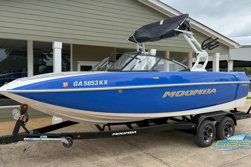 Slide: The Image of 2021 Moomba Craz blue boat on trailer, parked outside a building. - 14