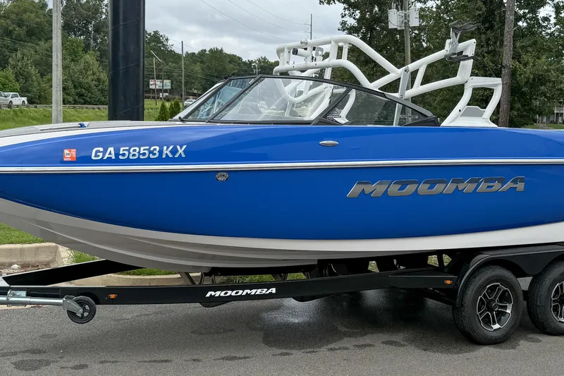 Slide: The Image of 2021 Moomba Craz boat in blue on a trailer, side view. - 16