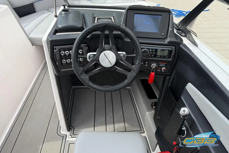 Slide: The Image of 2021 Moomba Craz boat dashboard with steering wheel and control panel. - 18