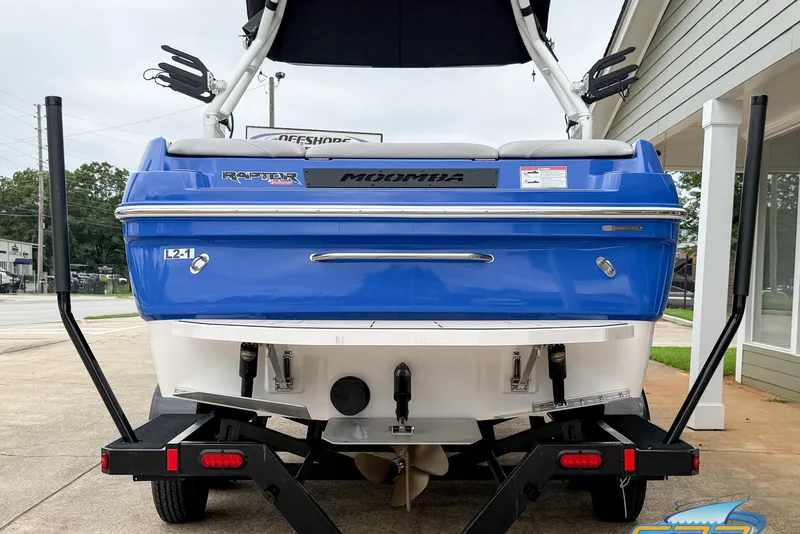 Slide: The Image of 2021 Moomba Craz boat, blue exterior, on trailer, rear view. - 22
