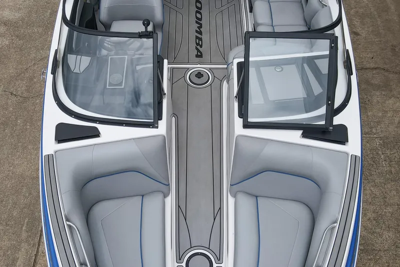 Slide: The Image of 2021 Moomba Craz boat interior with gray seating and open windshield. - 24