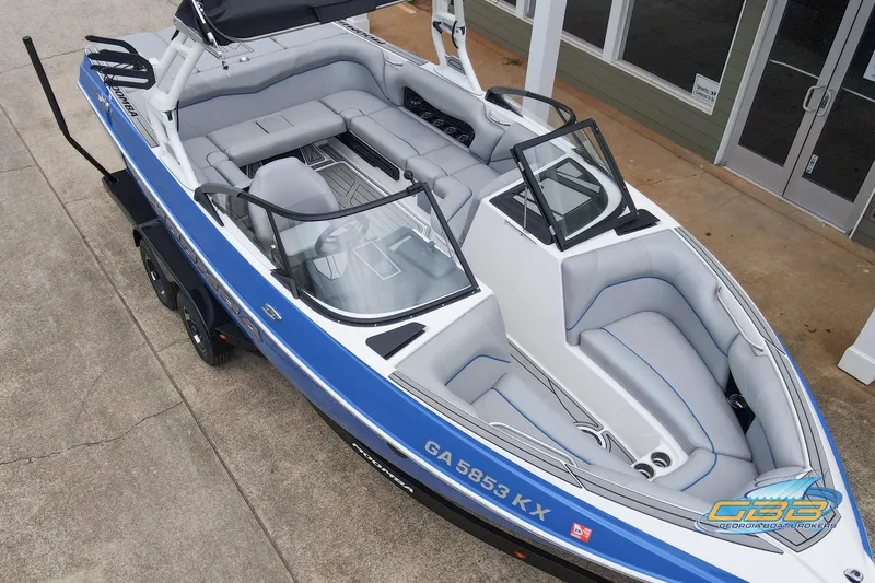 Slide: The Image of 2021 Moomba Craz boat with blue and white exterior, spacious seating, and modern design. - 25