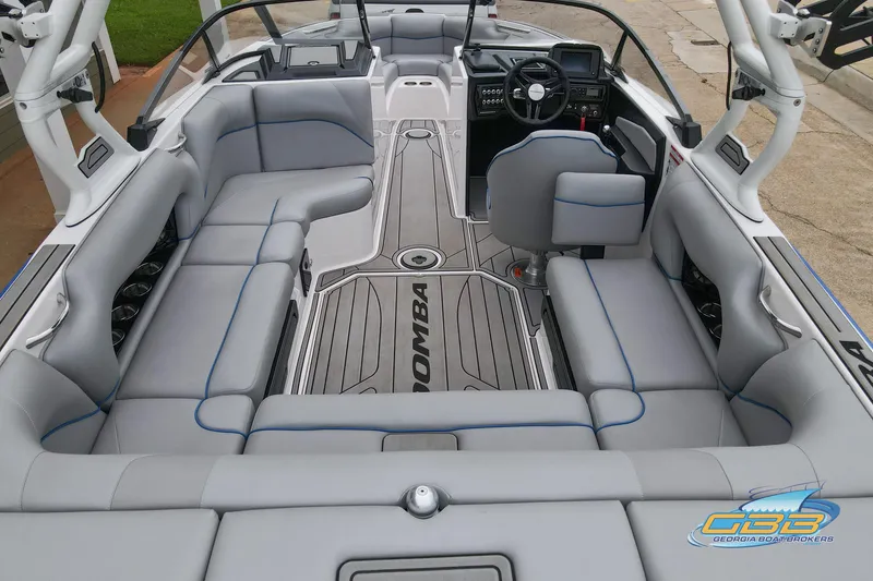 Slide: The Image of 2021 Moomba Craz boat interior with gray seating and modern dashboard design. - 27