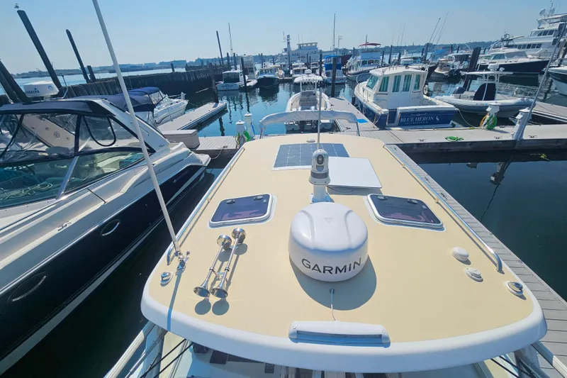 Slide: The Image of 2023 MJM 35 yacht docked at marina, featuring Garmin equipment on deck. - 15