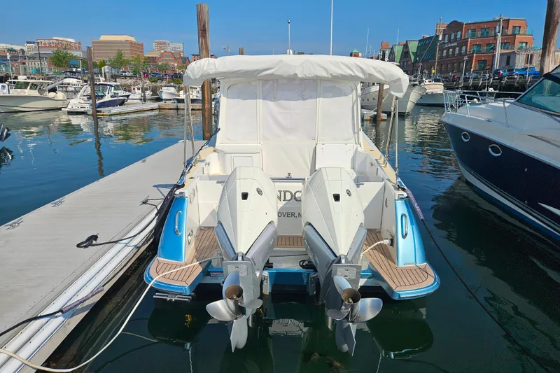 Slide: The Image of 2023 MJM 35 boat docked at marina with twin outboard engines. - 42