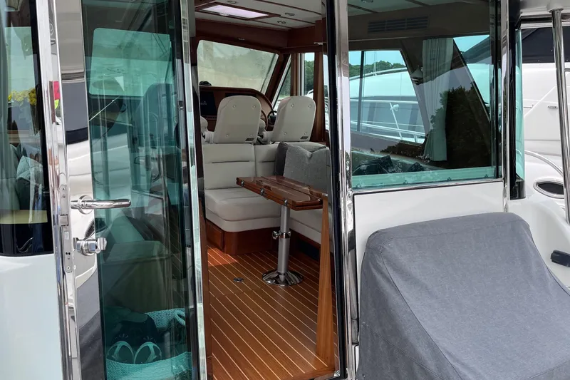 Slide: The Image of Luxurious interior of 2022 Sabre 48 Salon Express with plush seating and wooden finishes. - 13