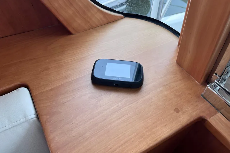 Slide: The Image of 2022 Sabre 48 Salon Express helm with modern navigation equipment and luxurious seating. - 15