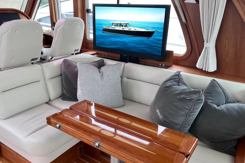 Slide: The Image of 2022 Sabre 48 Salon Express helm with dual screens and wooden steering wheel. - 16