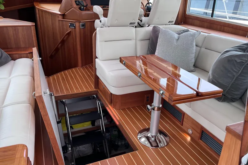 Slide: The Image of Luxurious 2022 Sabre 48 Salon Express yacht interior with elegant wood cabinetry and modern kitchen amenities. - 19