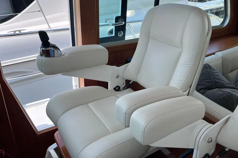 Slide: The Image of 2022 Sabre 48 Salon Express bathroom with shower, sink, and wooden cabinetry. - 27