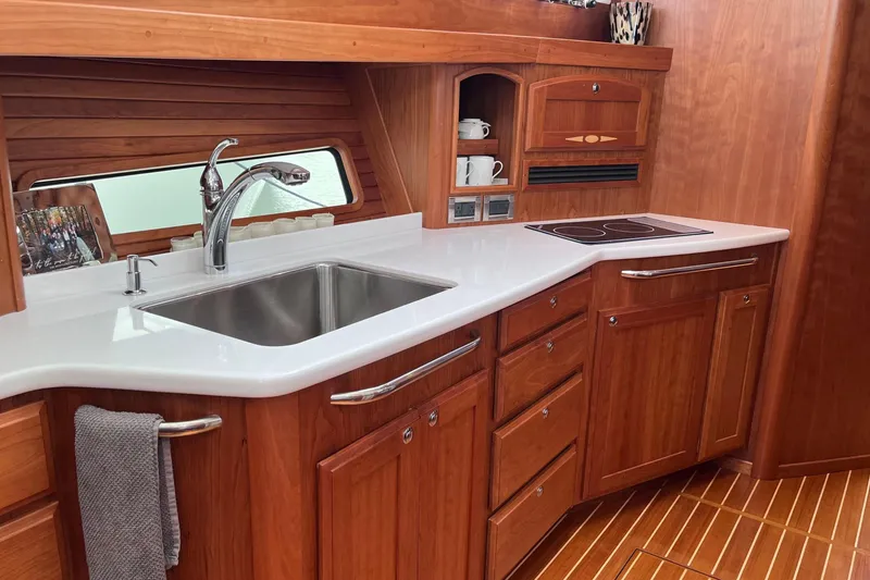 Slide: The Image of Cozy bedroom interior of 2022 Sabre 48 Salon Express yacht with wooden accents. - 31