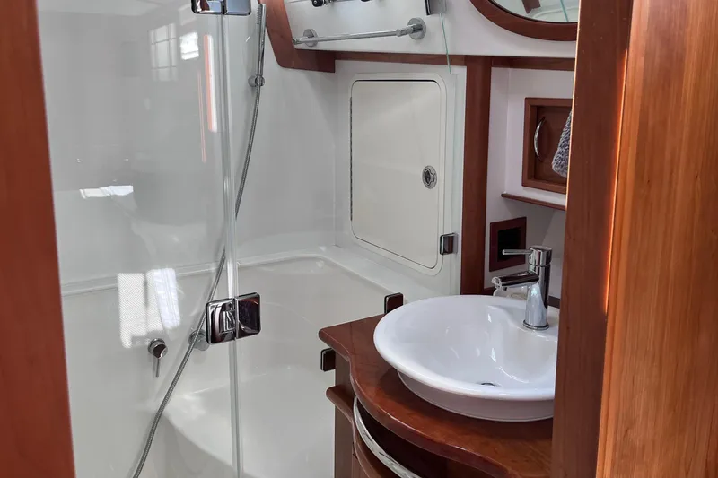 Slide: The Image of 2022 Sabre 48 Salon Express yacht deck with seating, table, and American flag. - 44