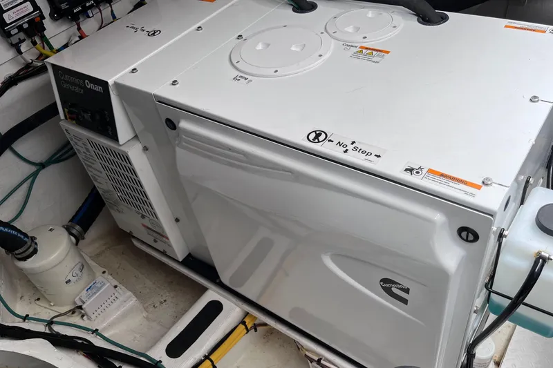 Slide: The Image of 2022 Sabre 48 Salon Express cruising on open water, displaying sleek design and American flag. - 57