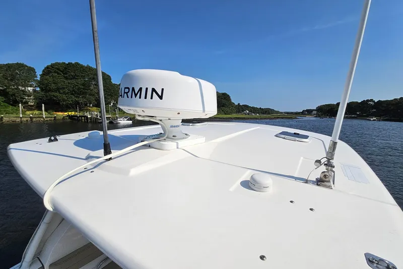 Slide: The Image of 2018 Pursuit DC 295 Dual Console boat with Garmin radar on calm water. - 13