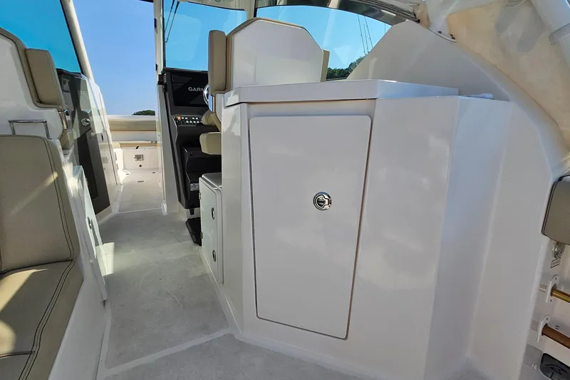 Slide: The Image of 2018 Pursuit DC 295 Dual Console interior with seating and storage compartments. - 23