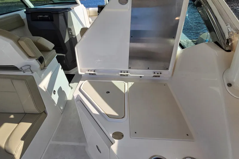 Slide: The Image of 2018 Pursuit DC 295 Dual Console interior with seating and storage compartments. - 24