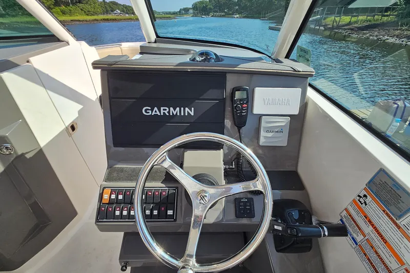 Slide: The Image of 2018 Pursuit DC 295 Dual Console boat dashboard with Garmin and Yamaha controls. - 28