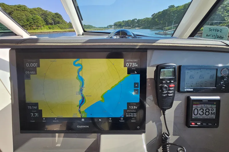 Slide: The Image of 2018 Pursuit DC 295 Dual Console boat dashboard with Garmin navigation system and controls. - 30